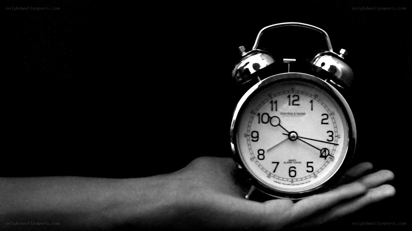 hand holding alarm clock