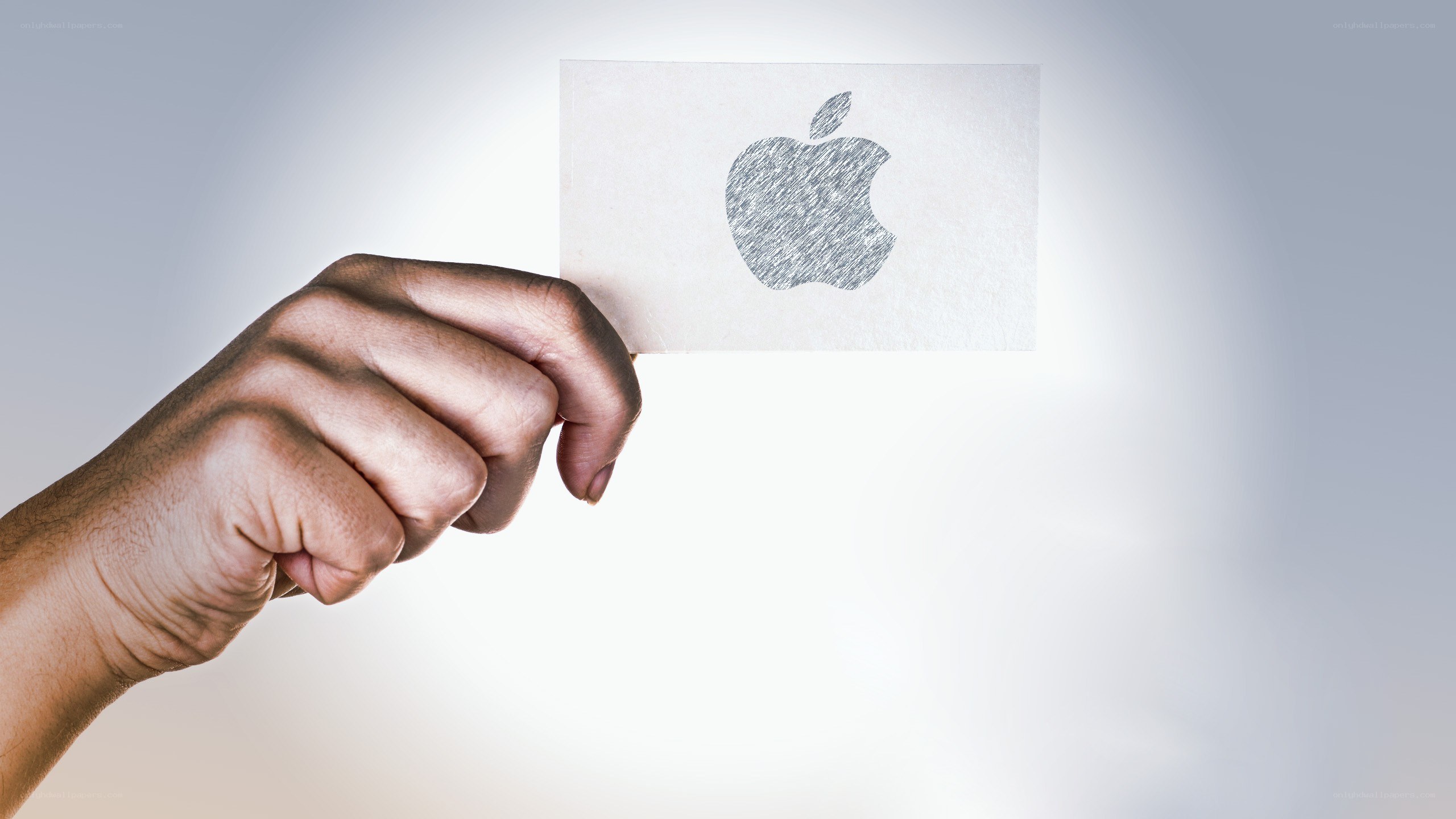 hand holding apple logo card