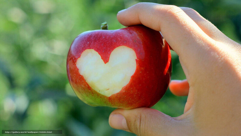 hand holding apple with heart cutout