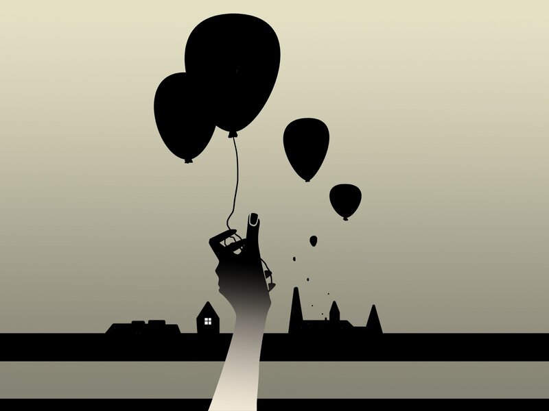 hand holding balloons at dusk
