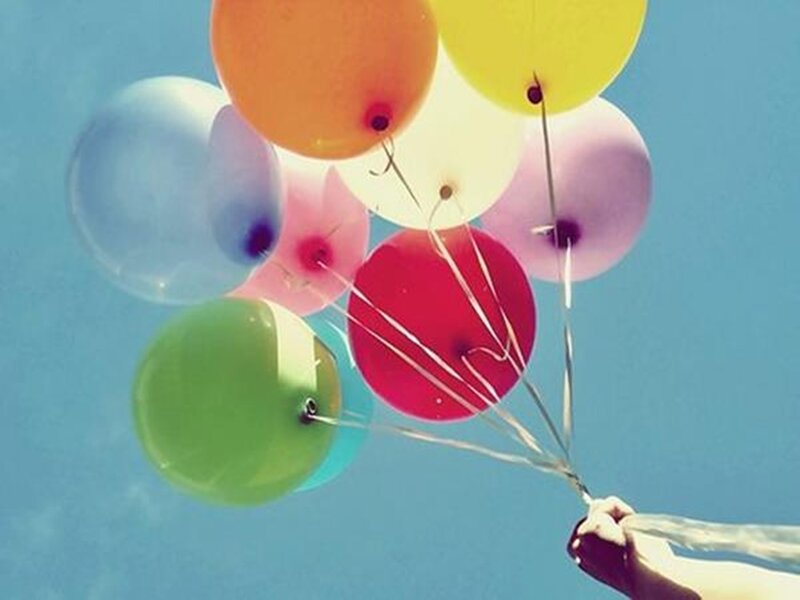 Hand Holding Balloons