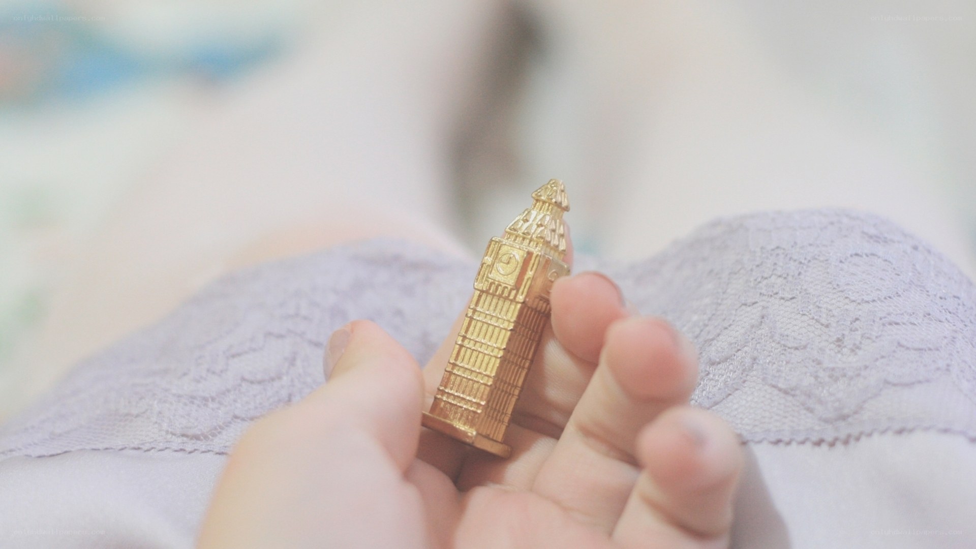 Hand holding Big Ben figurine
