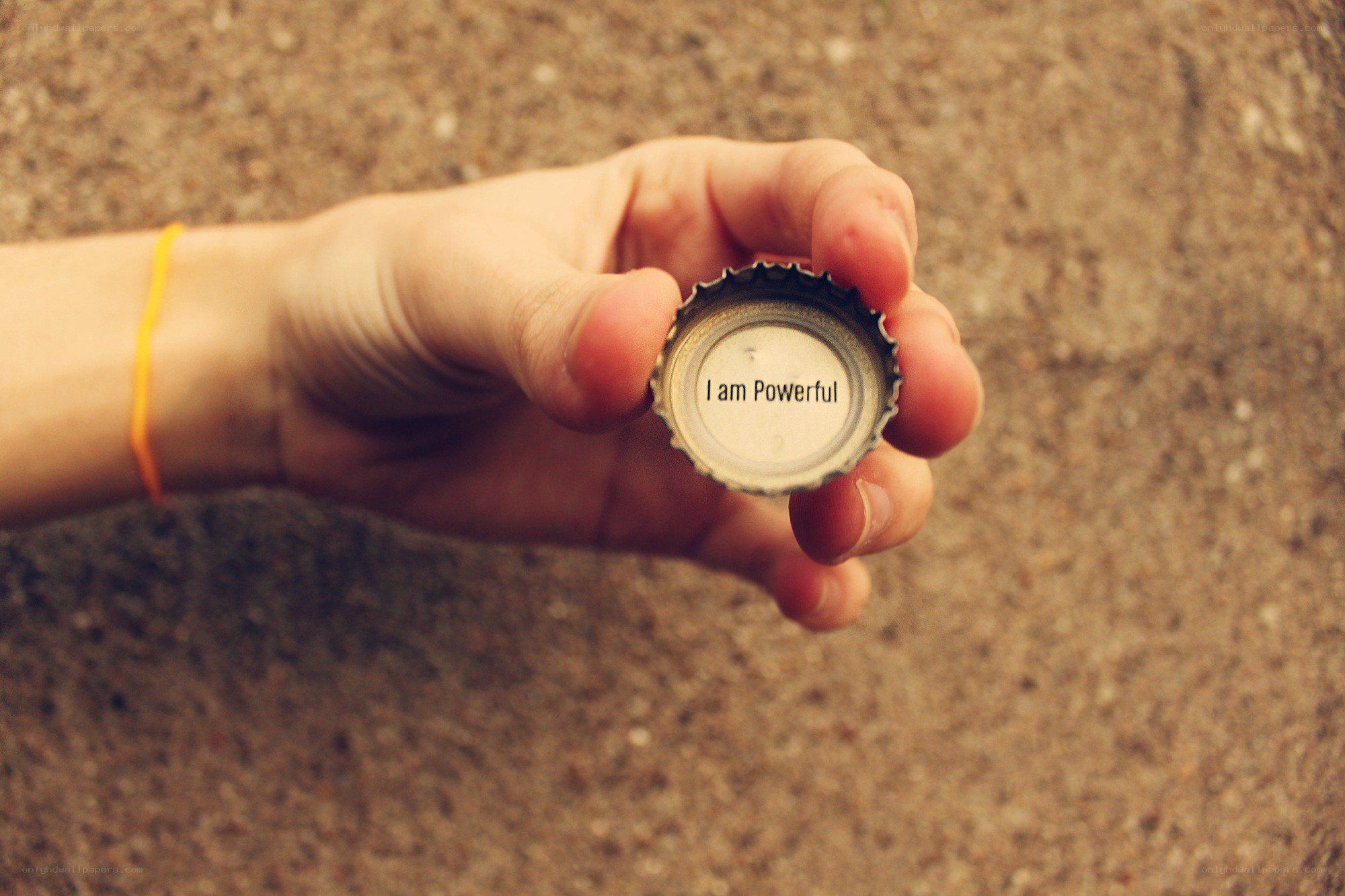 hand holding bottle cap
