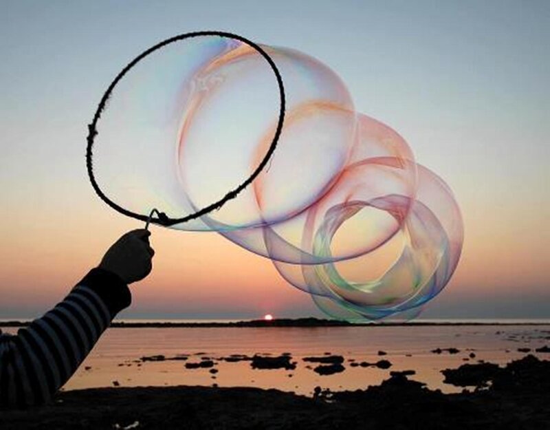 Hand Holding Bubble Wand — Orange