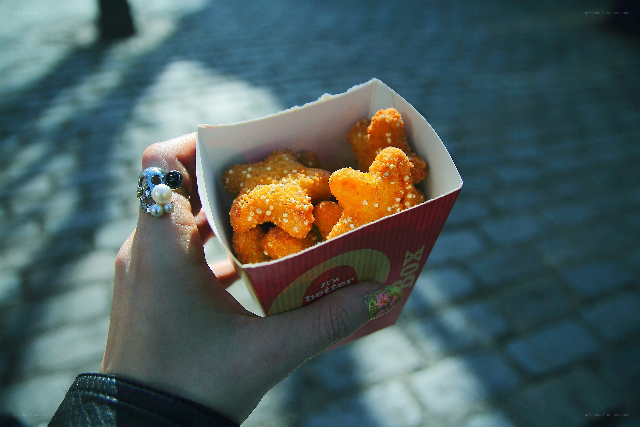 hand holding chicken nuggets