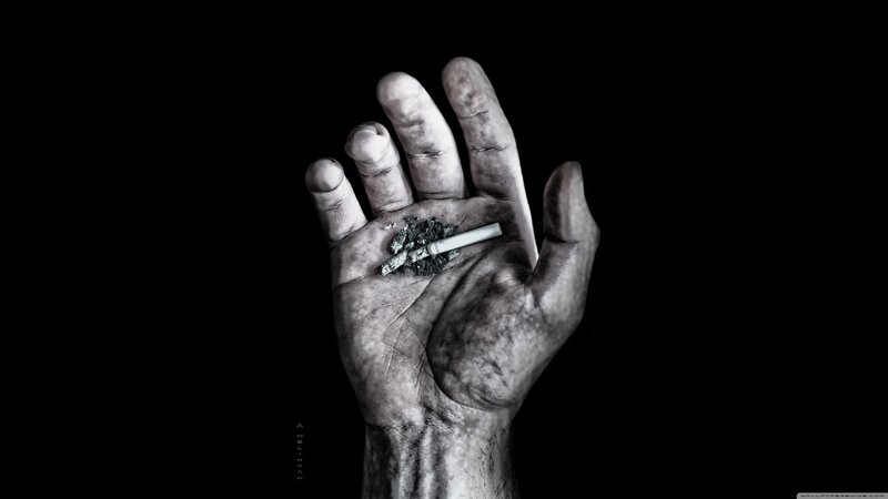 hand holding cigarette ash