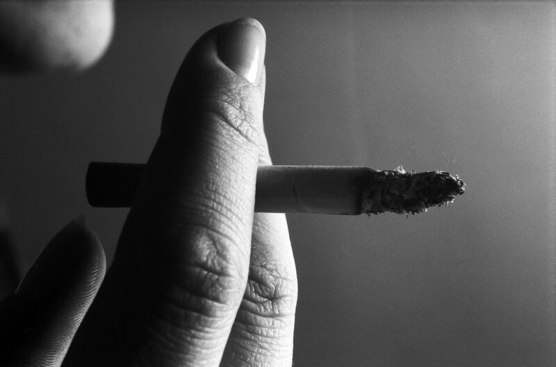 Hand Holding Cigarette — Black, Dramatic