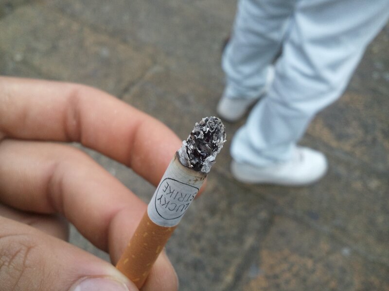 Hand Holding Cigarette — Brown