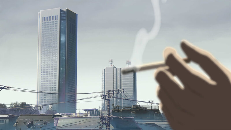 Hand holding cigarette in city