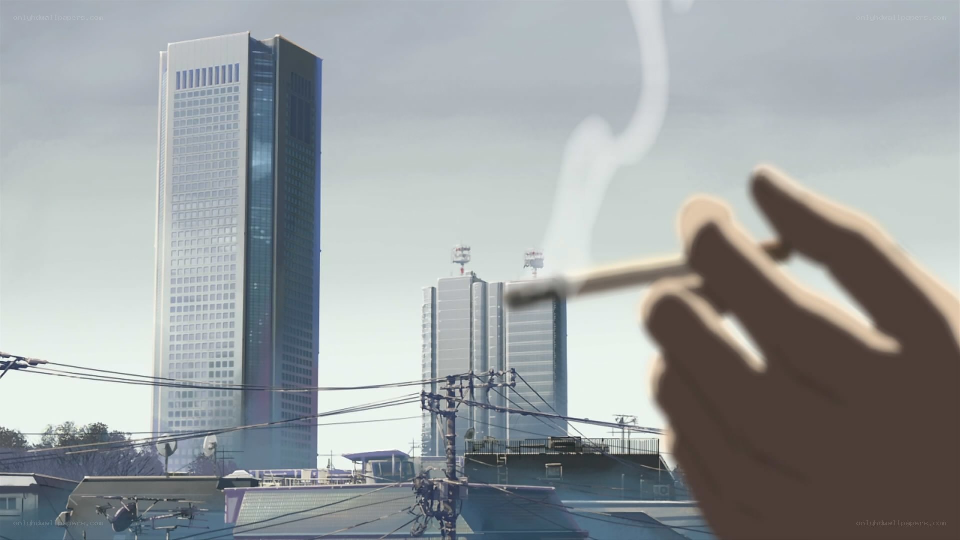 Hand holding cigarette in city