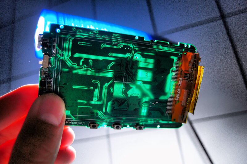 Hand Holding Circuit Board — Green