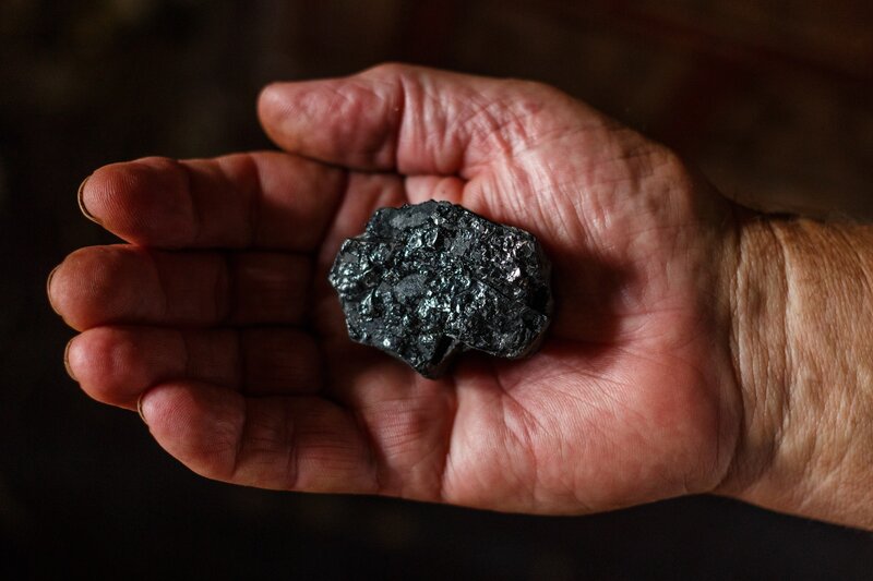 Hand Holding Coal