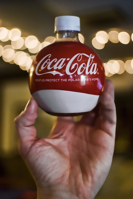 Hand holding Coca-Cola bottle