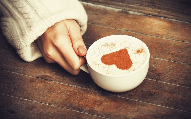 Hand Holding Coffee Cup — Brown
