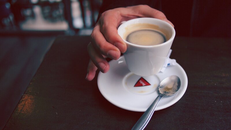 hand holding coffee cup