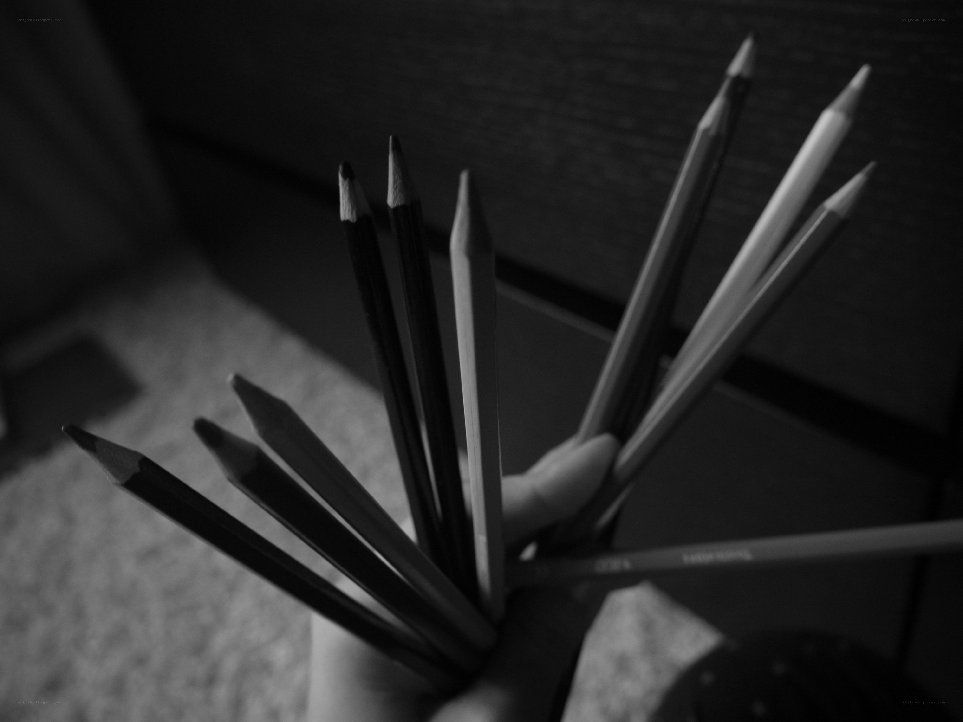 hand holding colored pencils