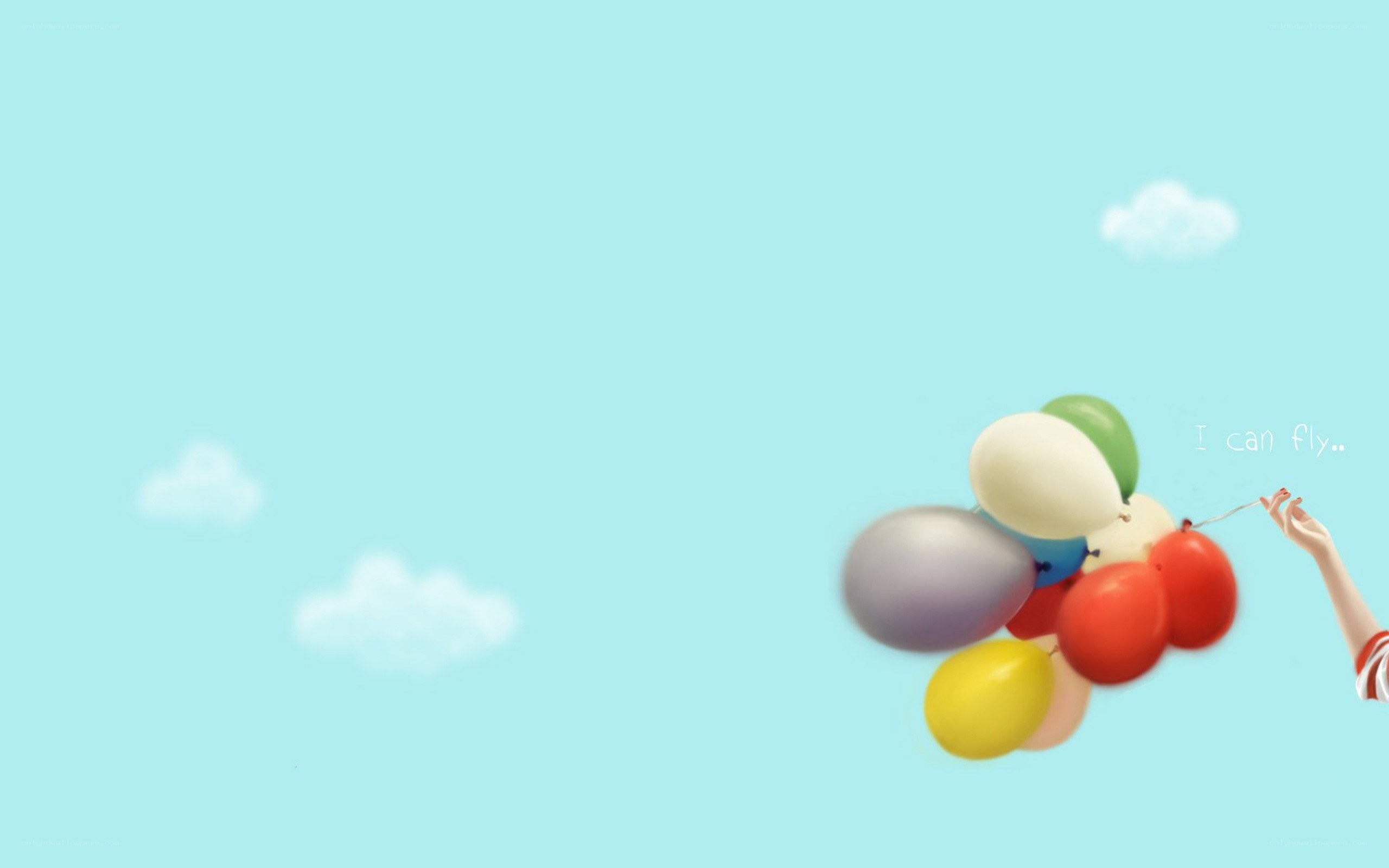 hand holding colorful balloons