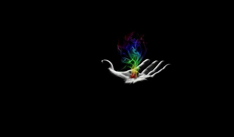 hand holding colorful smoke