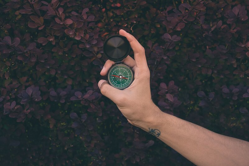 hand holding compass