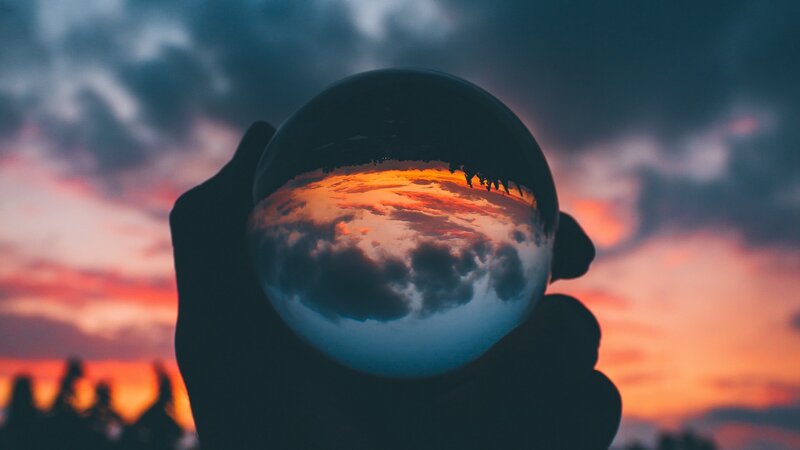 Hand Holding Crystal Ball — Orange, Dramatic