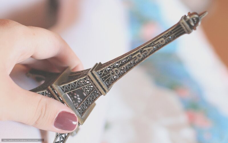 Hand Holding Eiffel Tower Model — Brown