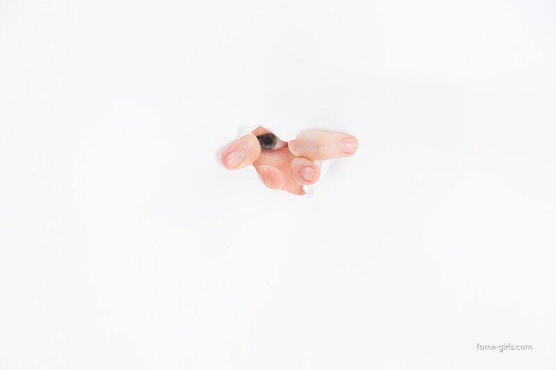 hand holding eye through paper