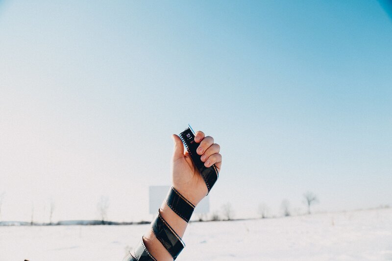 Hand Holding Film Strip — Blue