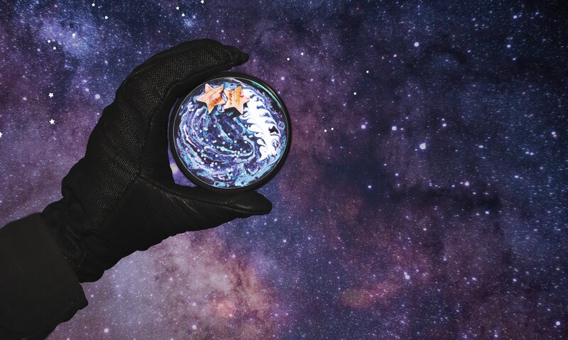 hand holding galaxy sphere