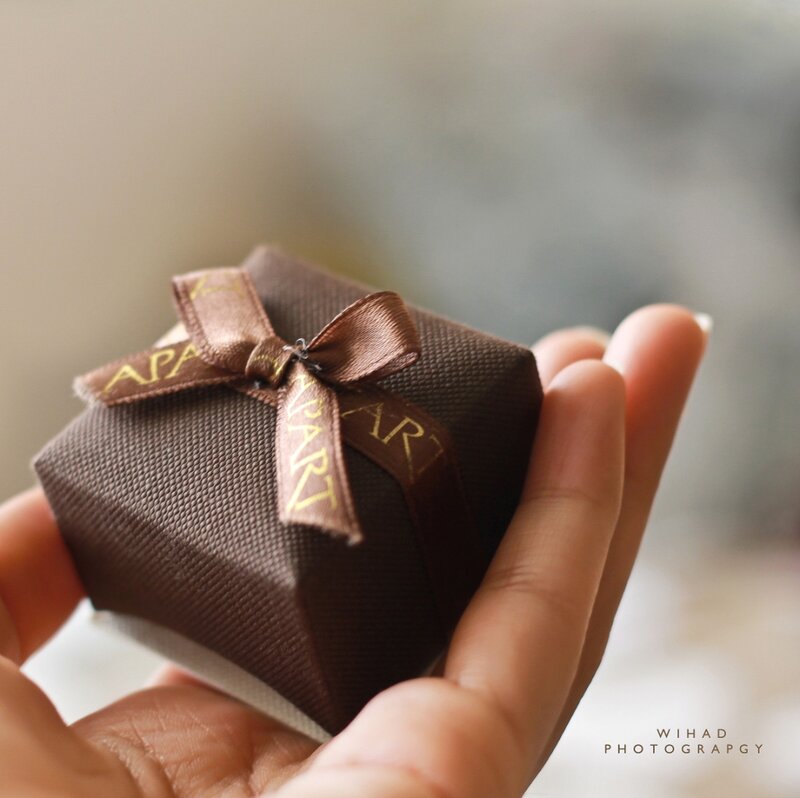 Hand Holding Gift Box — Brown