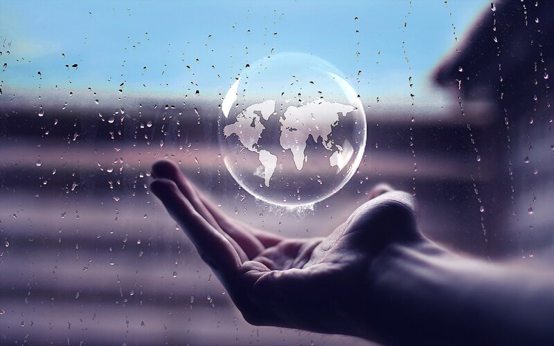 hand holding globe bubble