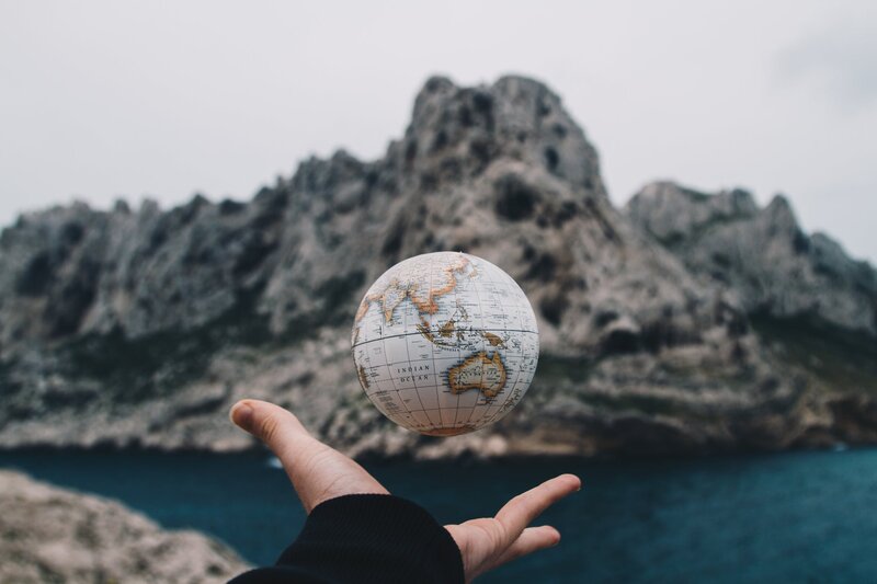 Hand Holding Globe — White