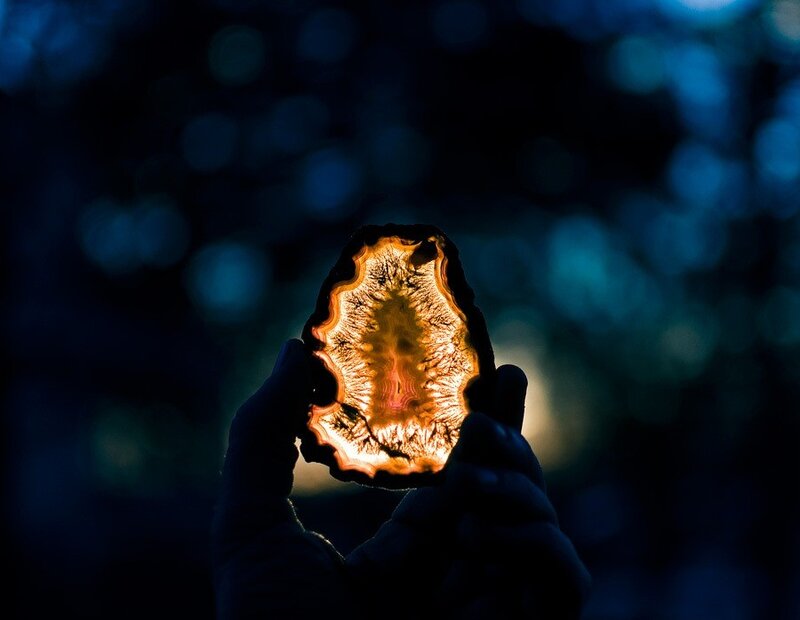 Hand holding glowing agate slice