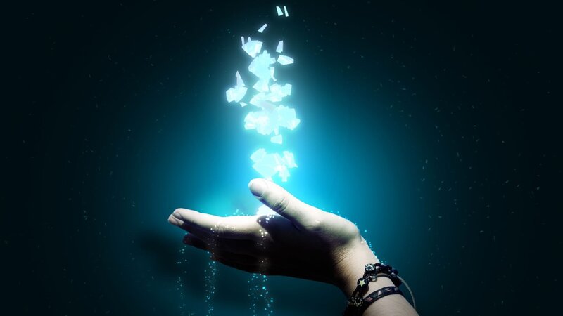 hand holding glowing fragments