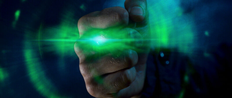 hand holding glowing green device