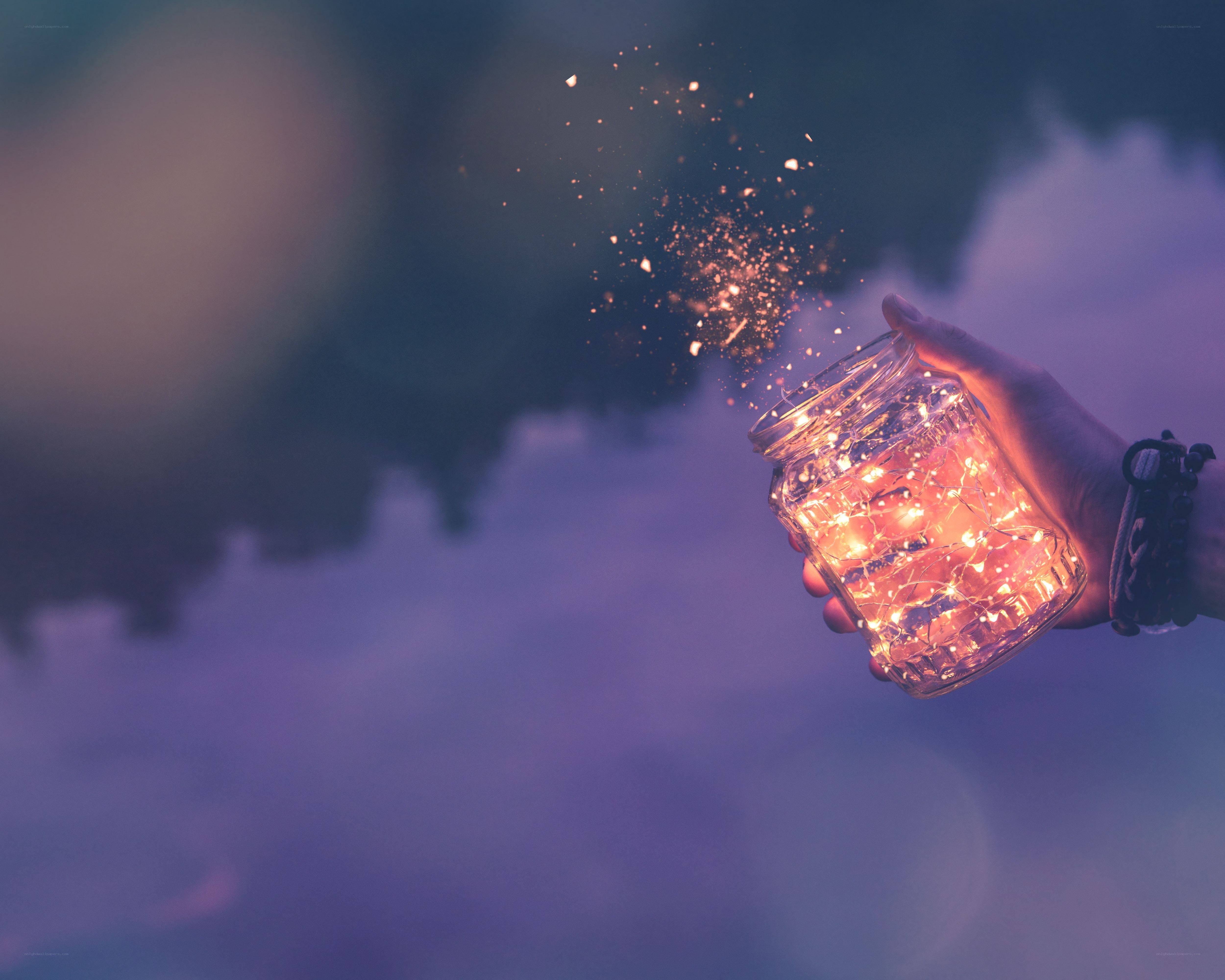 hand holding glowing jar