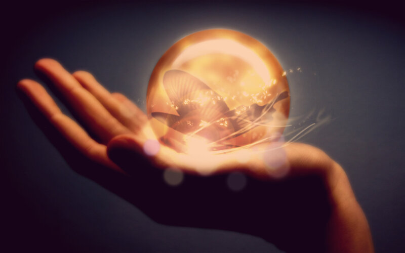 Hand Holding Glowing Orb — Gold