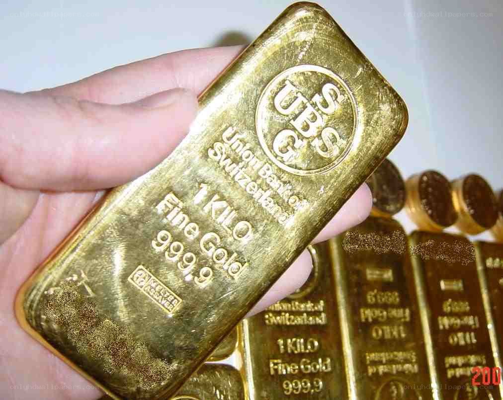 Hand holding gold bar