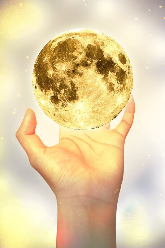 Hand Holding Golden Moon