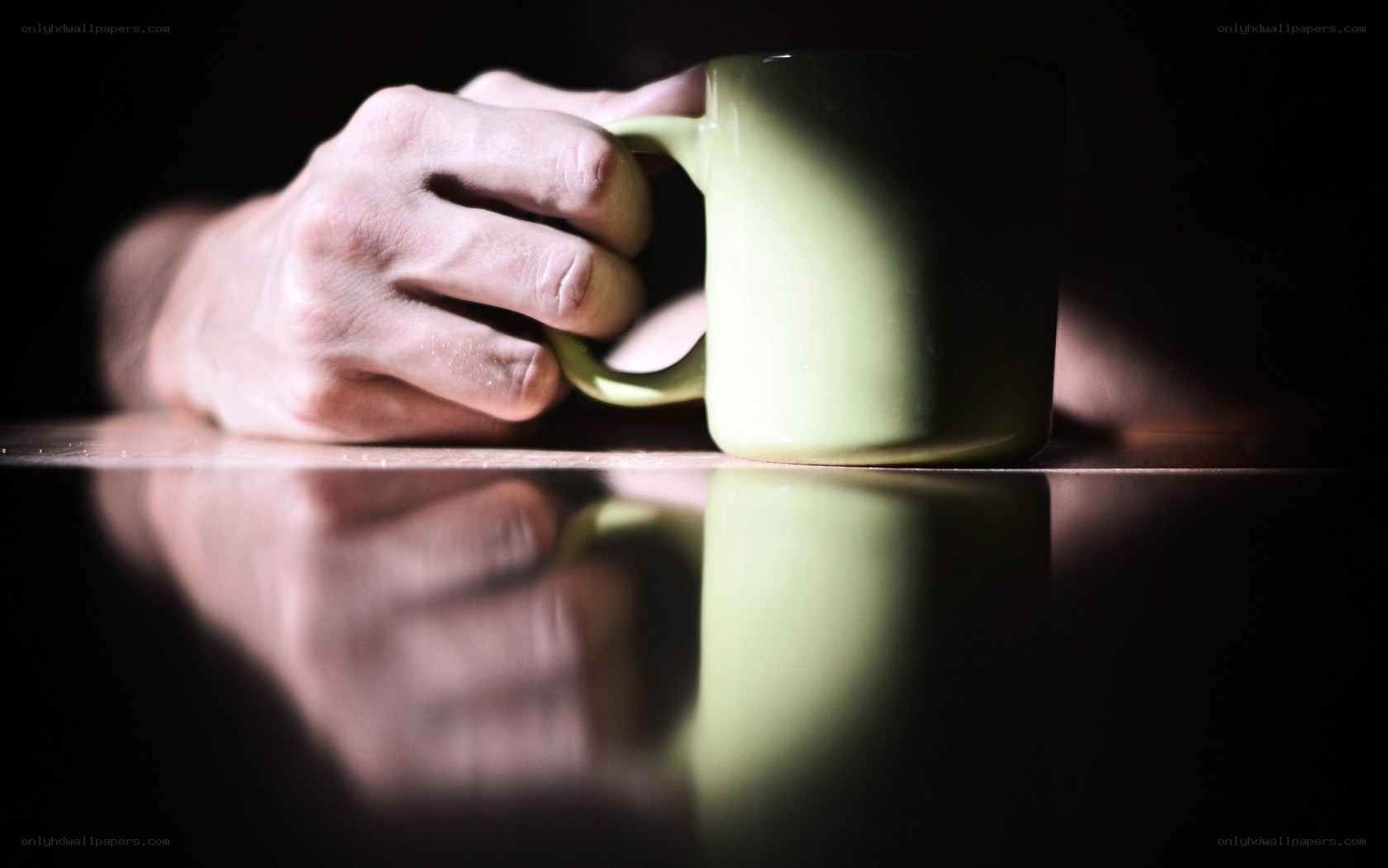 hand holding green mug