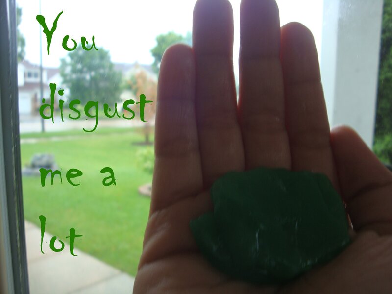 Hand Holding Green Object