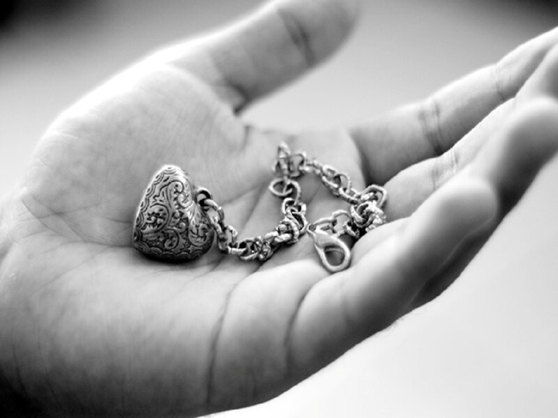 Hand Holding Heart Locket — Black
