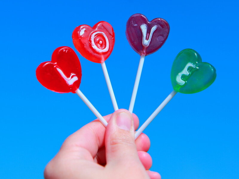 Hand Holding Heart Lollipops — Blue