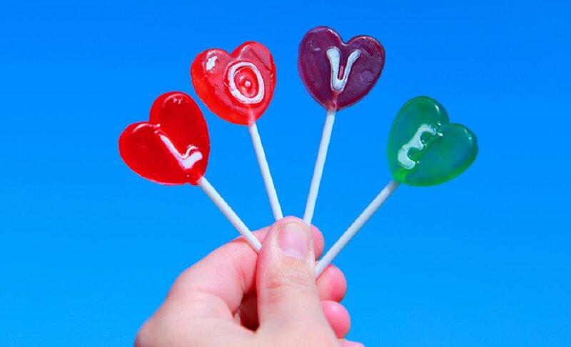 Hand Holding Heart Lollipops