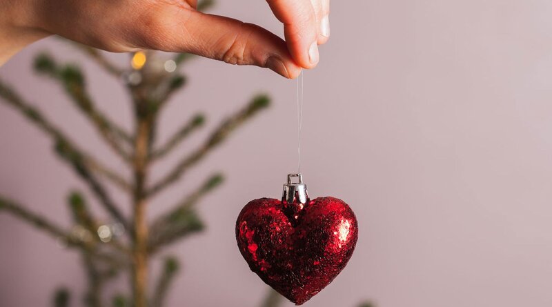 Hand Holding Heart Ornament — Red