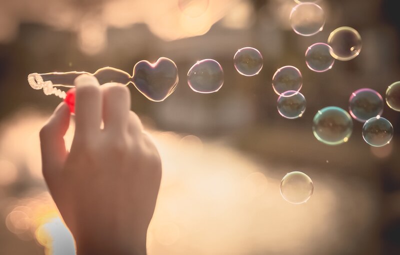 Hand Holding Heart-shaped Bubble Wand