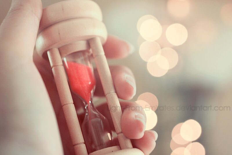 Hand Holding Hourglass
