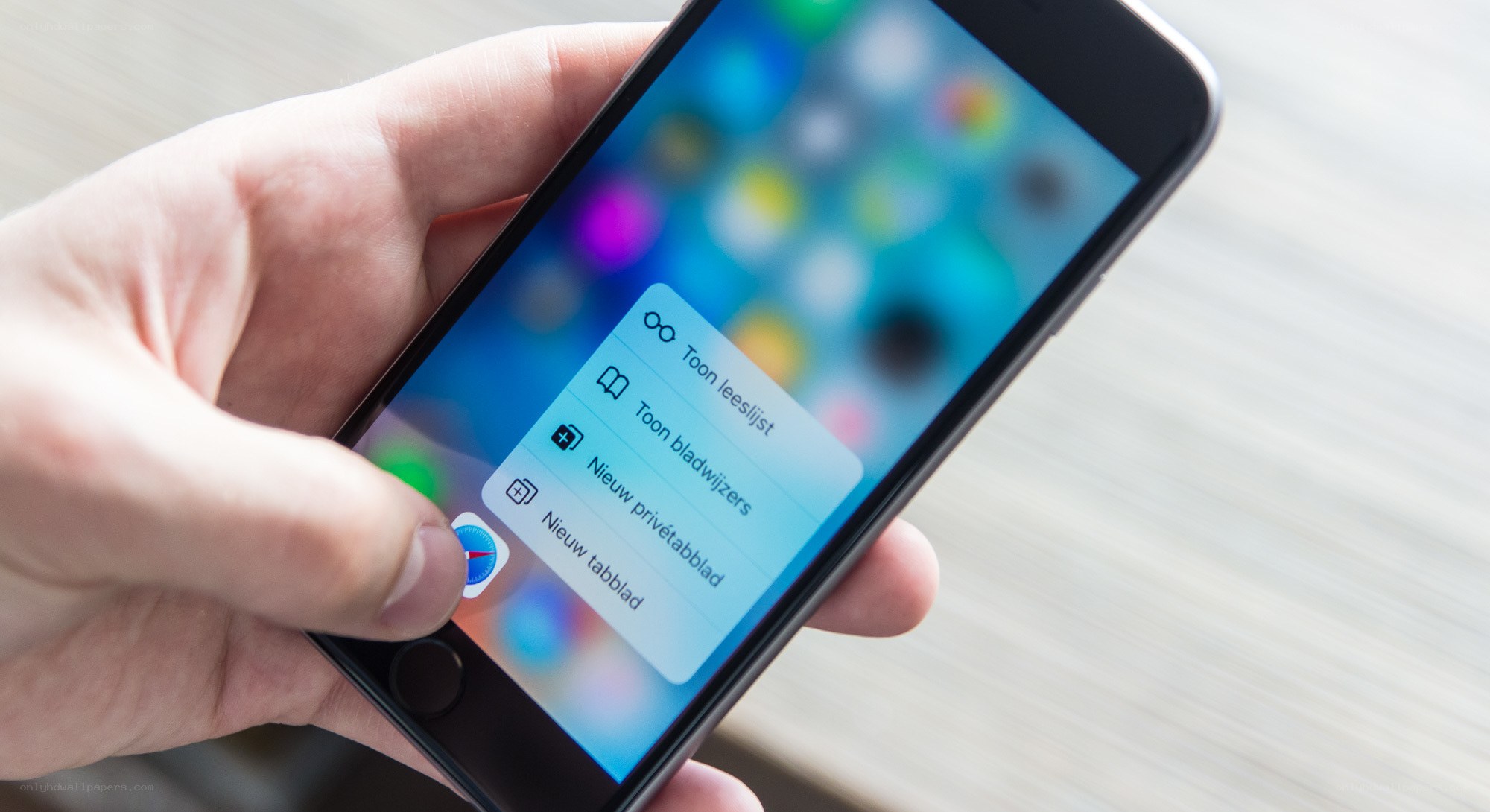 Hand holding iPhone with menu