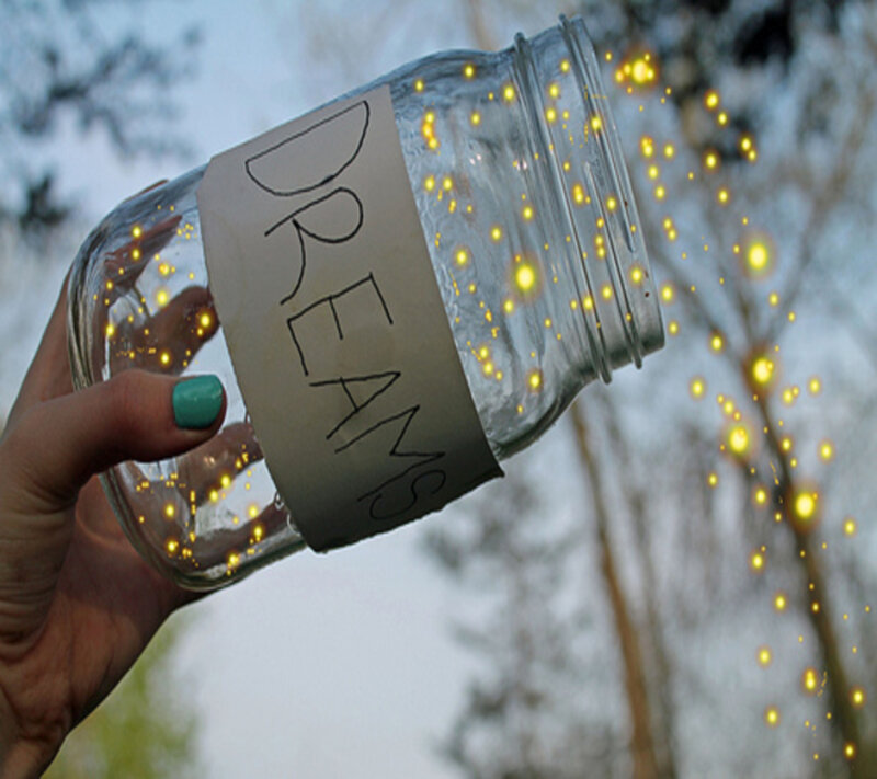 Hand Holding Jar of Fireflies