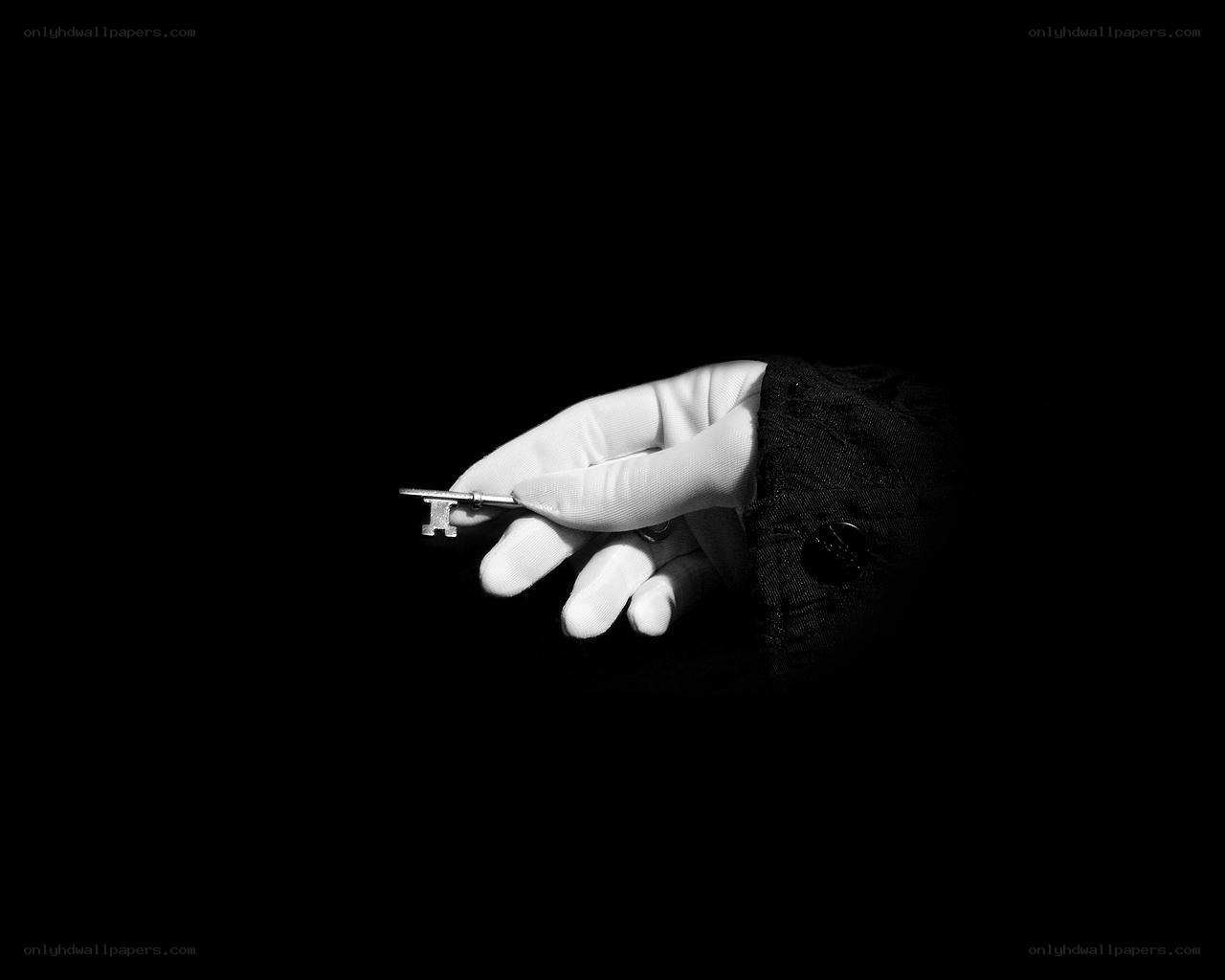 hand holding key in darkness