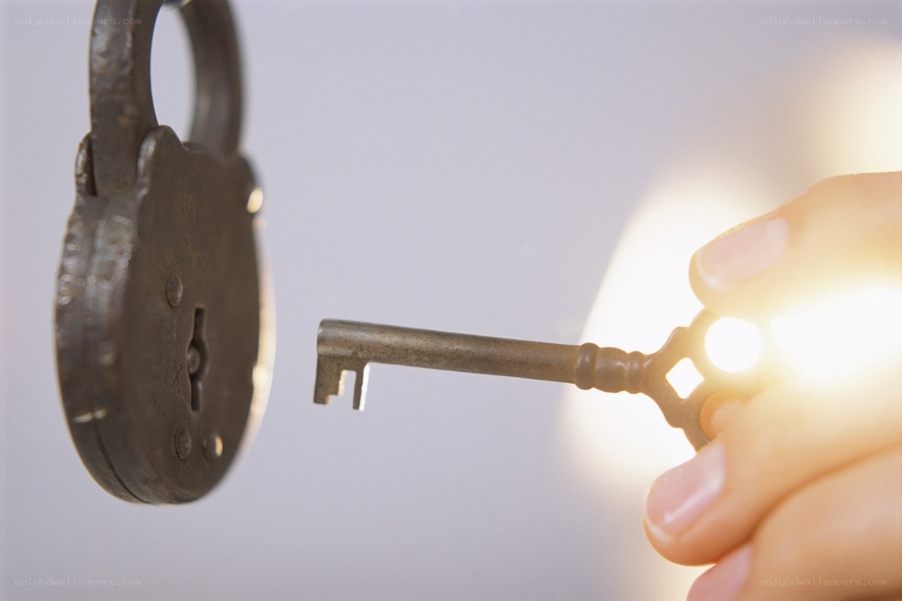 hand holding key to lock